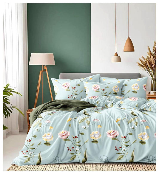 Floral bedding set on a bed in a bedroom with a green wall and lamp.