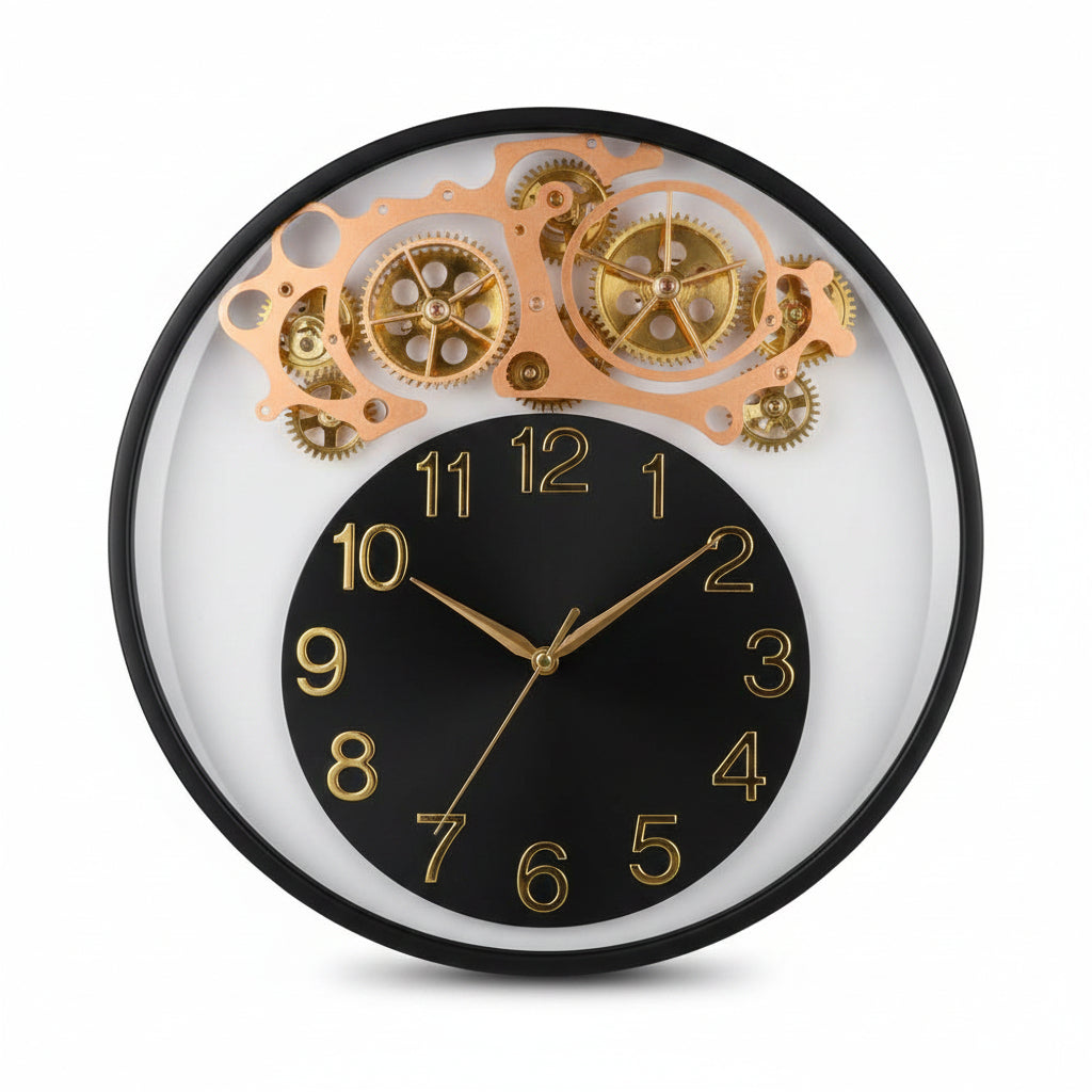A round wall clock with a black central face, gold Arabic numerals, and a decorative upper section showing gold-toned gear and wheel motifs against a clear outer ring.