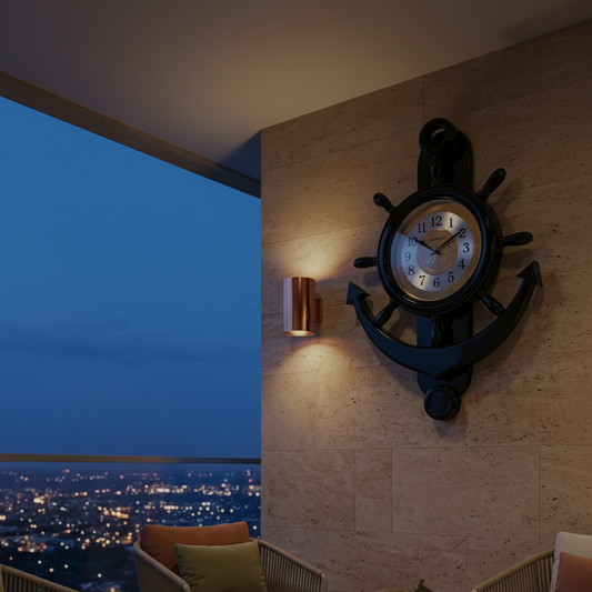 A nautical-themed wall clock with a ship's wheel and anchor design mounted on a stone wall in a modern living room setting. The scene includes a coffee table, chairs, and a city skyline view at dusk, with promotional text overlay reading 'Bold Nautical Statement'.